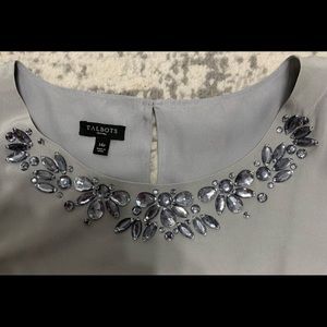 Gorgeous sleeveless blouse. Shell is 100% Silk. Lining is 100% Polyester.